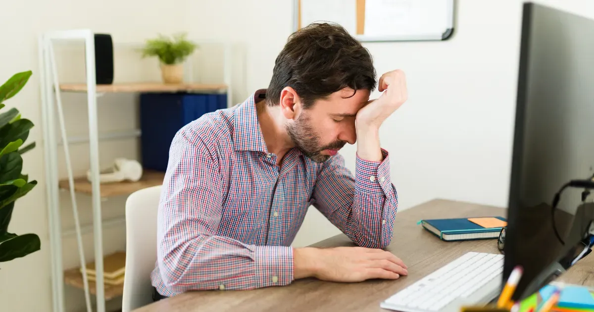 Man looking uncomfortable with hormonal imbalance symptoms.