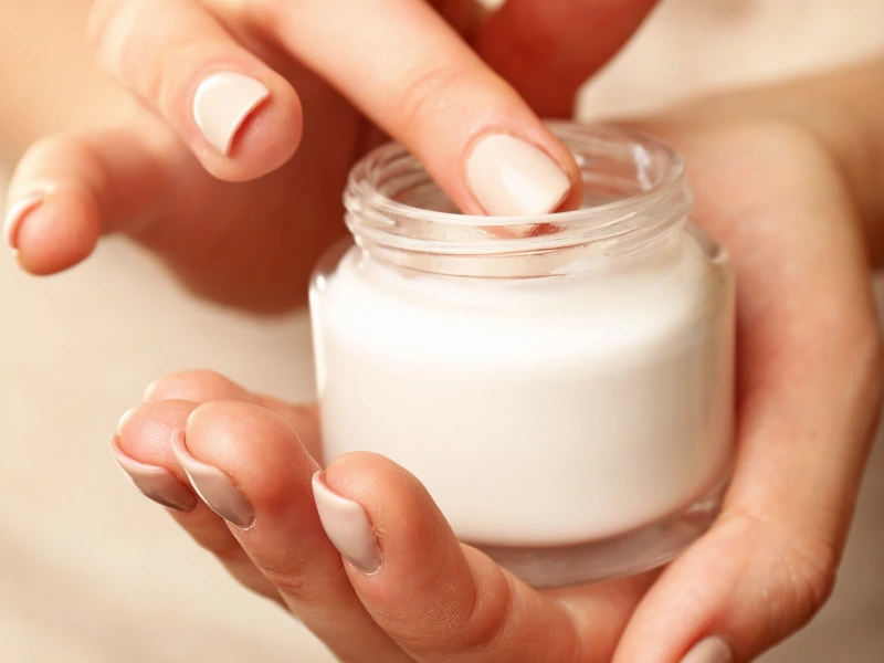 Person applying skincare.